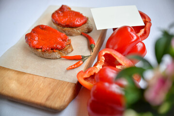 Bruschetta with dried paprika in a white plate on the table