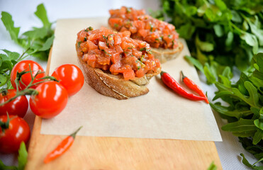 Bruschetta with salmon and herbs on a white plate
