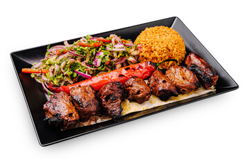 Delicious grilled meat platter served with colorful salad and rice