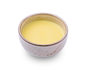Creamy yellow sauce in a handmade bowl for flavorful dishes