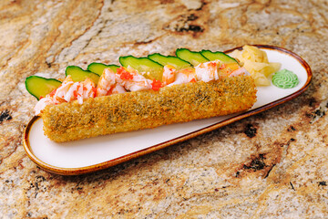 Sushi roll with shrimp and cucumber served on a decorative plate