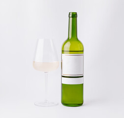 White wine bottle and glass on a simple background