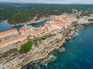 Aerial view marina cape Bonifacio south Corsica France citadel on rocky promontory on wild white limestone cliffs