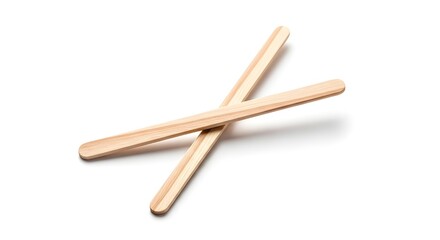 Two wooden stir sticks crossed on white background