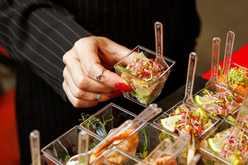 Hand holding small catering appetizer cup