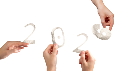 Hand holding silver metallic 2026 number in festive winter theme. Green and shiny foil typography