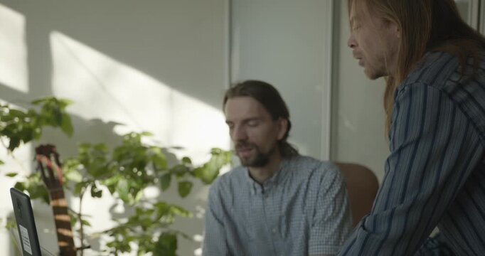 Two Male Coworkers Discuss Work Project in the Office. 4K 10-bit
