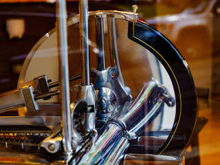 Old slicer exposed in a shop window of Milan, Italy