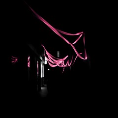 Pink Neon Light Art Installation in Dark Indoor Gallery Space