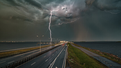 Lightning strike over coastal highway during storm