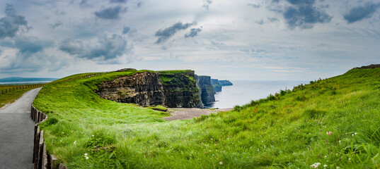 Beautiful scenery of the Cliffs of Moher in County Clare, Ireland.
View of the cliff and the Atlantic Ocean. Panoramic view.