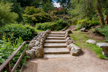 Stone steps surrounded by lush greenery in the Japanese Garden, Enniskerry, County Wicklow, Ireland – peaceful landscape and traditional garden design.