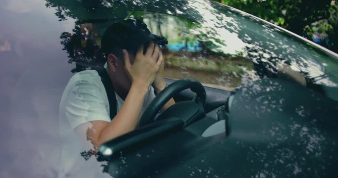 Man gripping steering wheel with clenched jaw, facing forward in silence, portraying mental strain, inner conflict, and emotional fatigue during difficult moment in car