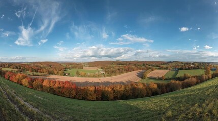 Naklejka premium Panoramic autumn landscape with rolling hills and colorfu...