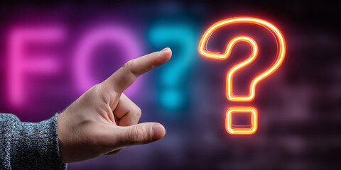 Male hand reaching for glowing question mark in neon lights at night