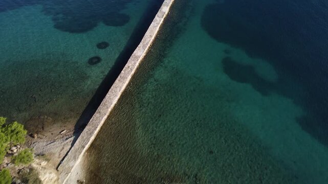water polo field by the sea, by the concrete jetty, sunny day, summer, calm sea, view from a drone