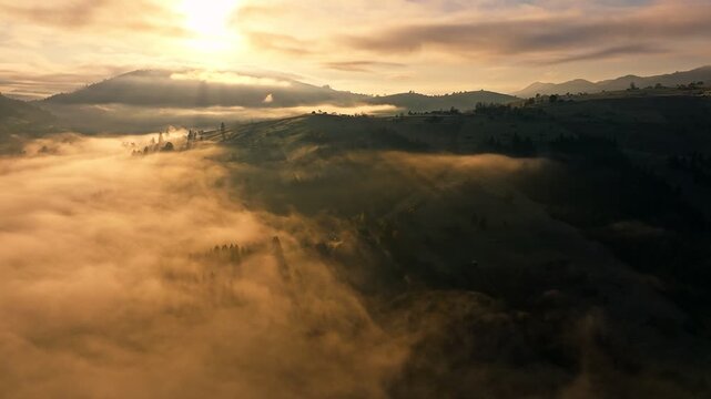 A Mesmerizing Sunrise Over the Misty Hills and Majestic Mountains