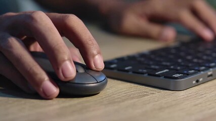 Close up view of male hands on computer keyboard and mouse - Powered by Adobe