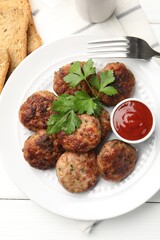 Delicious patties with parsley and ketchup served on white wooden table, flat lay