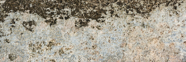Real weathered concrete wall with a heavy grunge texture. Featuring stained, dirty and distressed surface, perfect for urban backgrounds, edgy design, dramatic overlay, textural element.