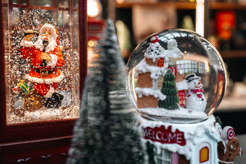 A Christmas souvenir crystal ball with a funny snowman inside, New Year's gifts and shopping at the holiday fair
