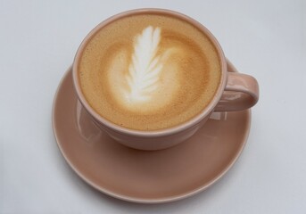 Cup of cappuccino in a pink ceramic mug