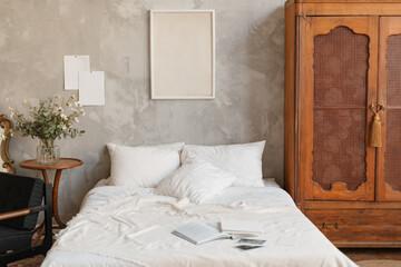 Open books and photographic prints on a tidy bed in an elegant classic eclectic styled bedroom