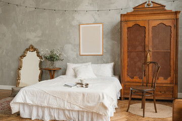 An open book, mug and tea towel on a tidy bed in an elegant classic eclectic styled bedroom