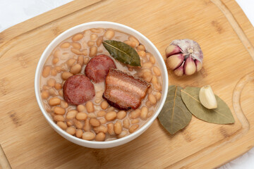 Beans with sausage and pork bacon