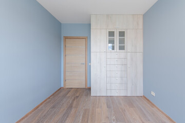 Home Living Room Interior. Wooden Floor, Bright Blue Color Walls, Window. Table and Black Chair.
