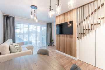 Luxury Living Room Interior. Modern Wide TV Screen. Sofa, Table Chairs and LED Light on the Ceiling.