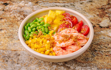 Colorful bowl of fresh ingredients featuring shrimp and vegetables