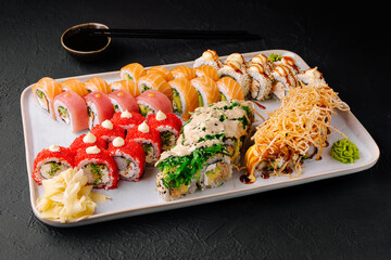 Sushi platter featuring colorful rolls served on a white plate