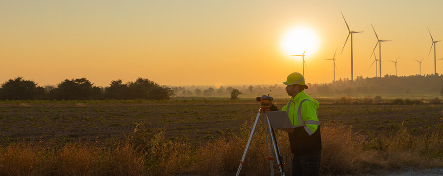 Survey Team Alternative energy for future. Engineers survey and checking wind turbines in sunset. Wind Turbine Renewable energy technology and sustainability.
