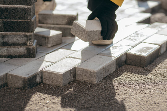 Laying paving stones in the courtyard of a new house