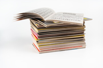 A stack of books and an open book, on a white background. Stack different notebooks, set.