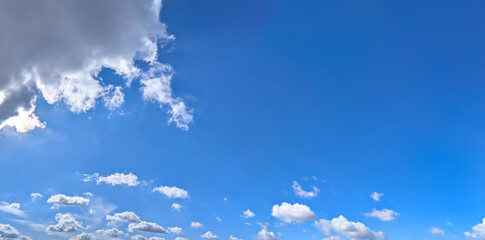 Diagonal composition banner with copy space inscription.. Blue sky filled many white clouds creating a peaceful and inspiring natural landscape scene.