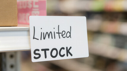 Store shelf with limited stock sign indicating restricted access during supply collapse