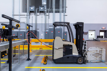 Electric forklift charging inside warehouse © Francisco