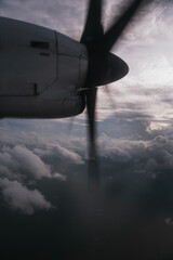 Airplane propeller spinning rapidly during flight, cutting through a dramatic cloudy sky, showcasing the thrill of aerial travel © Felix Morion