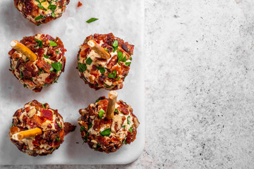 Three bacon balls are on a white plate