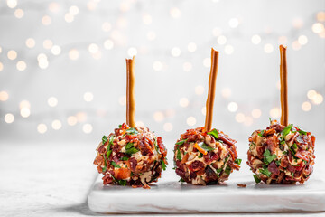 Three bacon balls are on a white plate