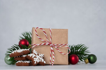 A brown box with a red ribbon on it