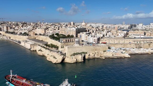 Aerial view of historic coastal city and fortress walls on a sunny day, 4K drone footage
