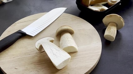 Close up of fresh boletus mushroom on wooden cutting board 