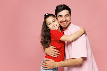 Young smiling cheerful happy parent man with child girl wear red casual clothes. Daddy little kid...