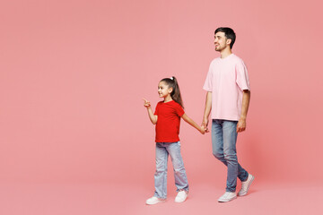 Full body young parent man with child girl wear red casual clothes. Daddy little kid daughter hold...