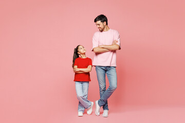 Full body young happy fun parent man with child girl wear red casual clothes. Daddy little kid daughter hold hands crossed folded isolated on plain pink background. Father's Day Love family concept.