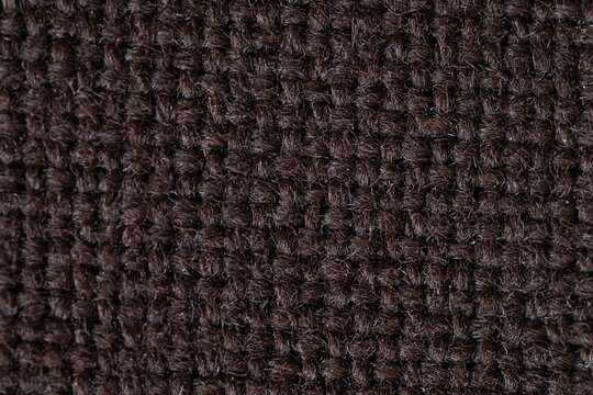 A macro close-up showcasing the rich, intricate textures of textile, tapestry, and leather materials