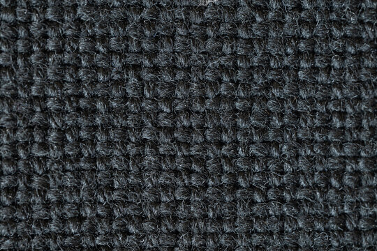 A macro close-up showcasing the rich, intricate textures of textile, tapestry, and leather materials